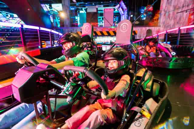 Indoor go-kart racing venue with vibrant lighting for team-building events in Wandsworth.