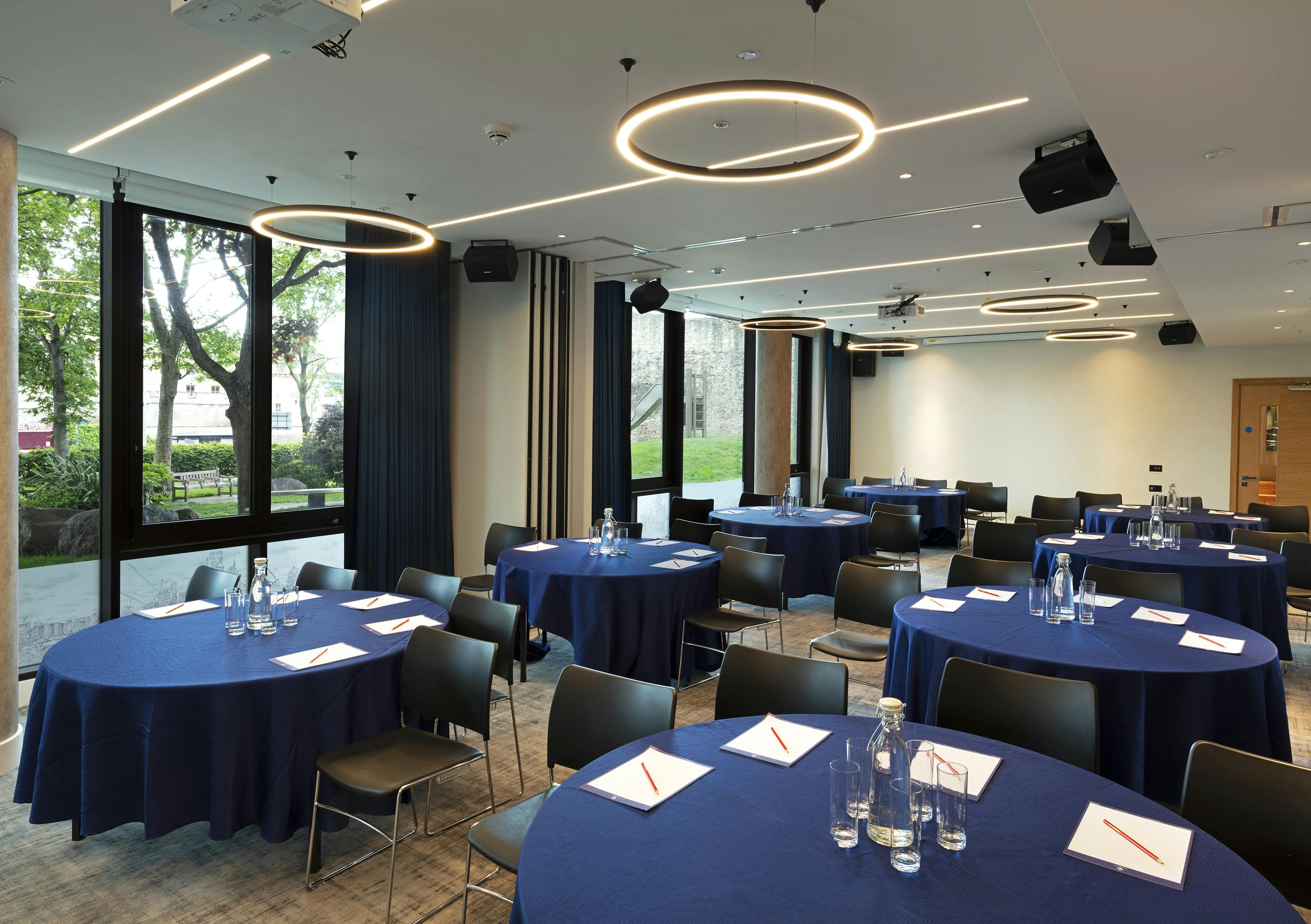 Royal Suite meeting space with navy blue linens for workshops and seminars.