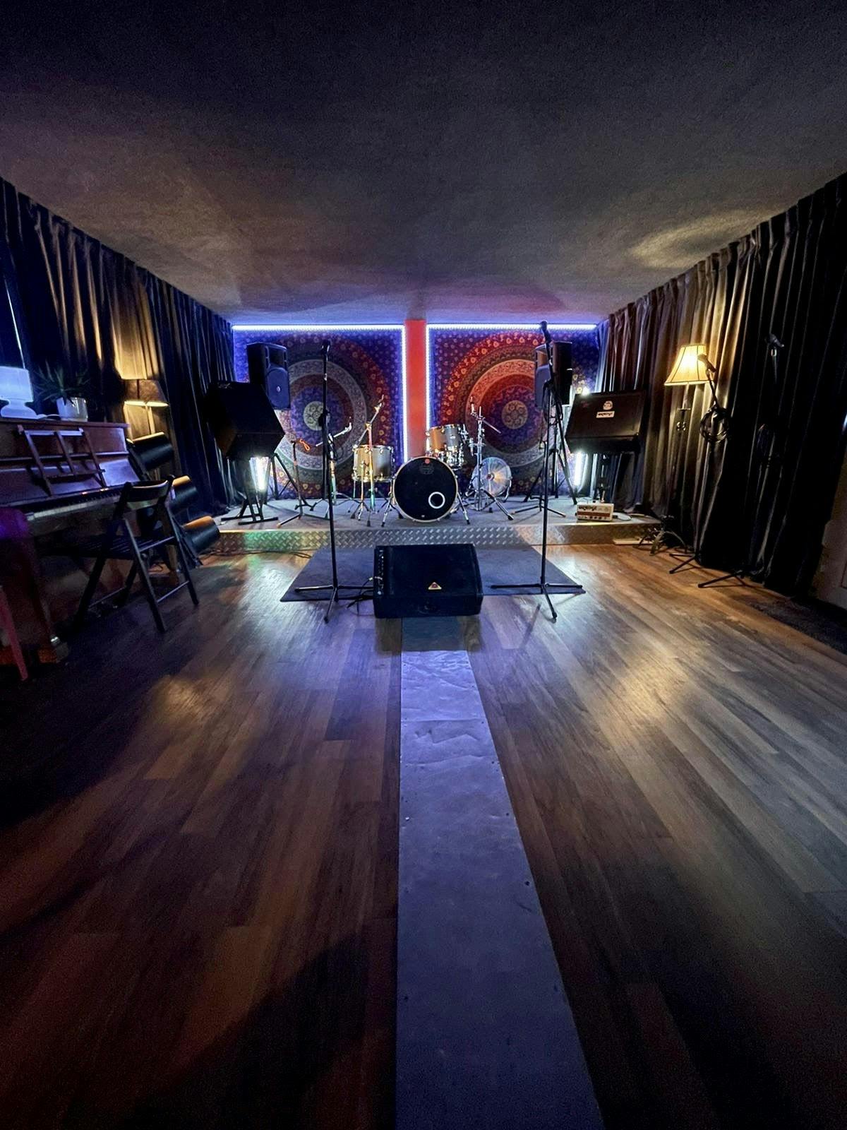 Versatile event space in Cargo Rooms with stage, ideal for live music performances.