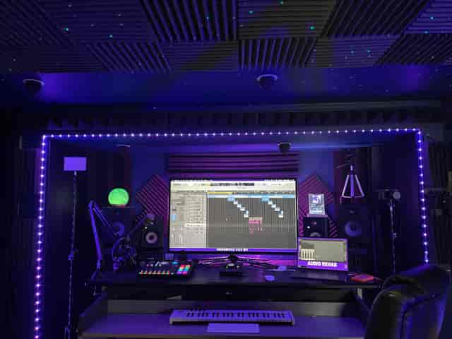 Modern audio production studio with ambient lighting for virtual events and recording sessions.