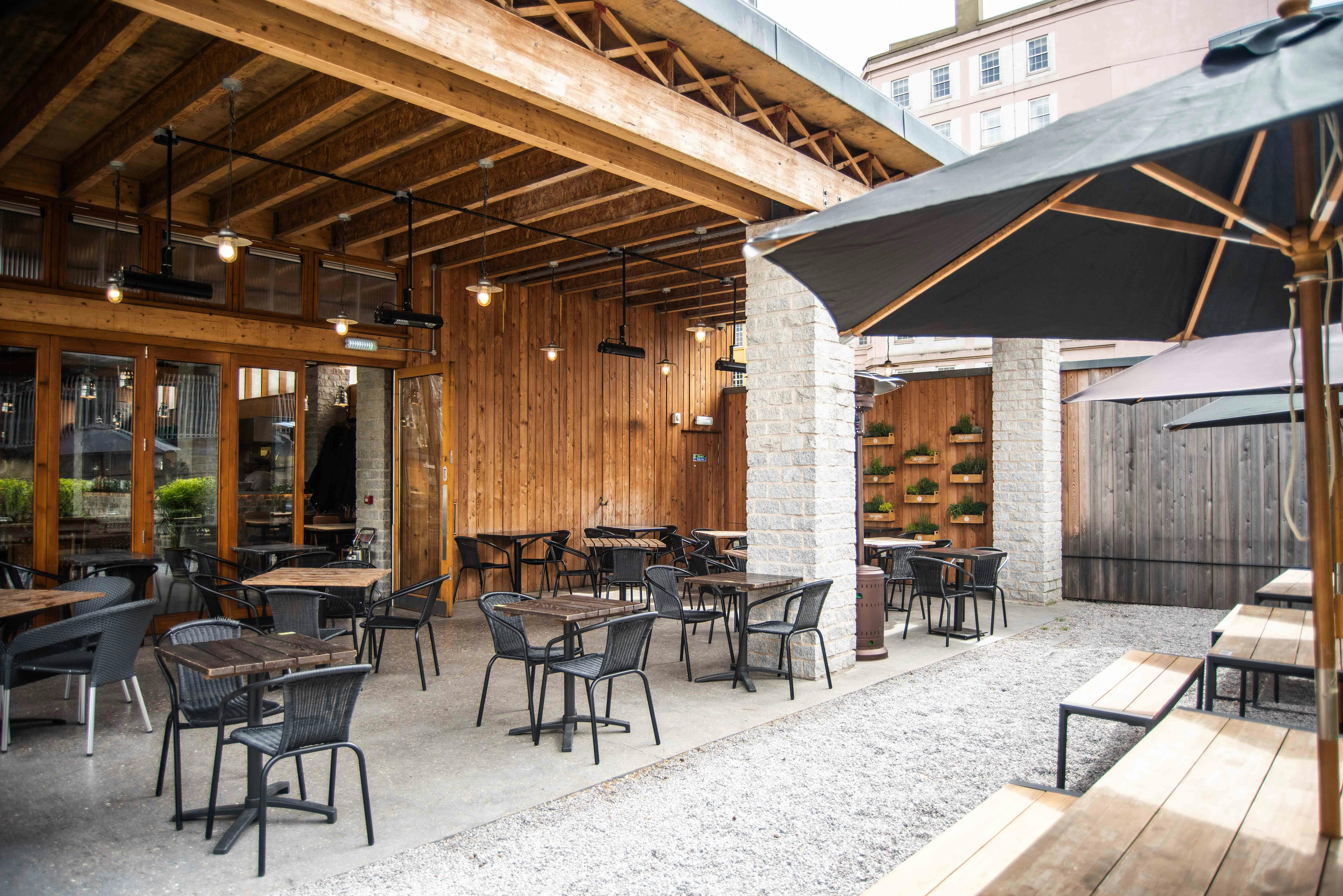 Versatile outdoor event space with rustic wooden design, ideal for gatherings and networking.