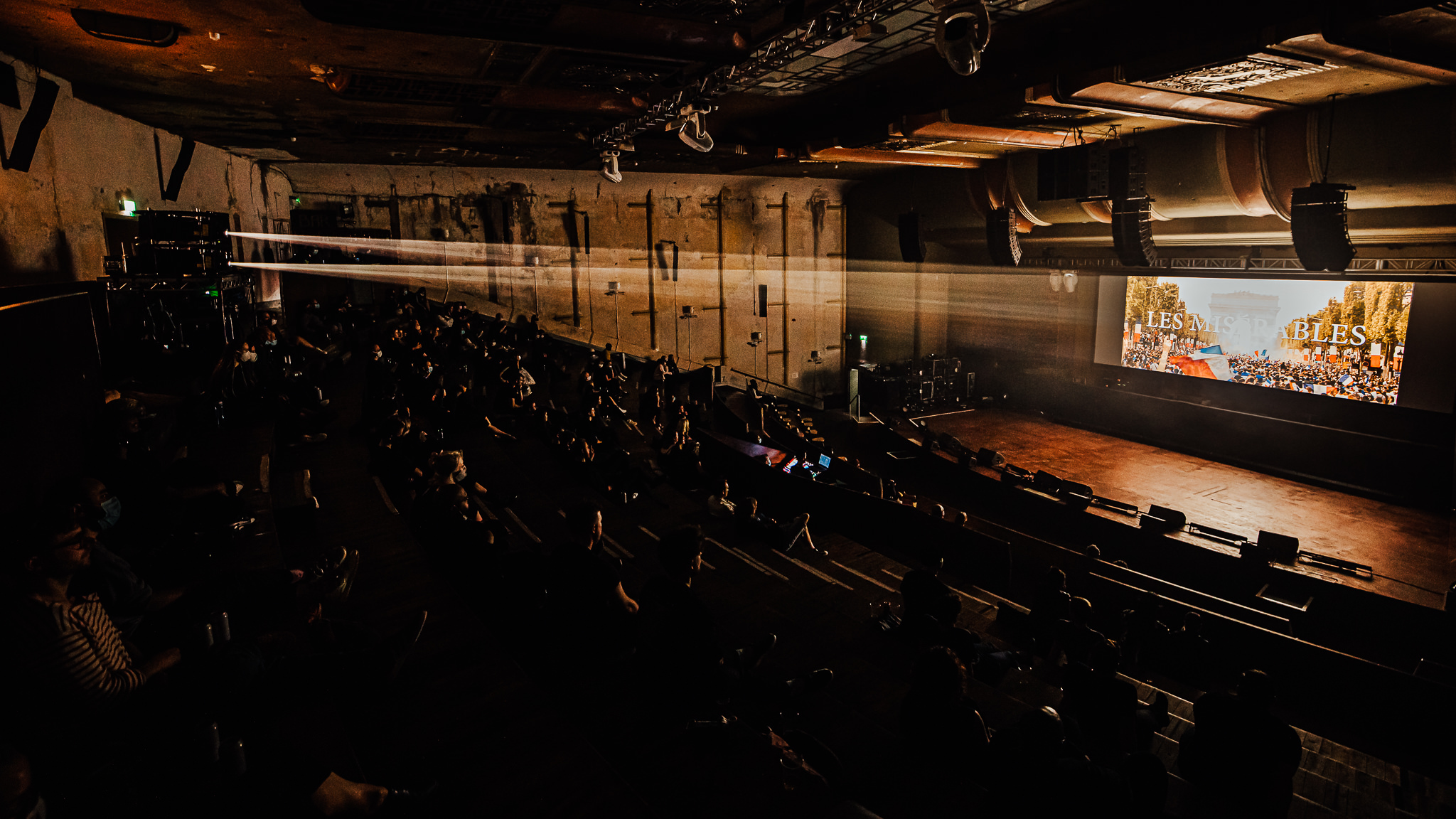 Theatre event at EartH with engaging stage setup and large screen visuals.