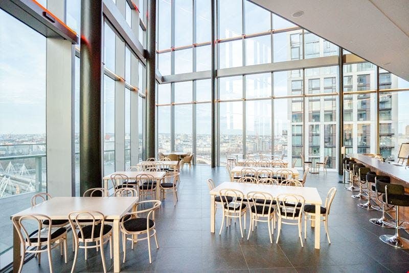 Modern event space with floor-to-ceiling windows, ideal for networking and workshops.