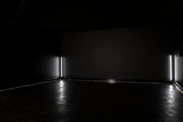 Minimalist event space in Blackout studio with dramatic lighting for immersive experiences.