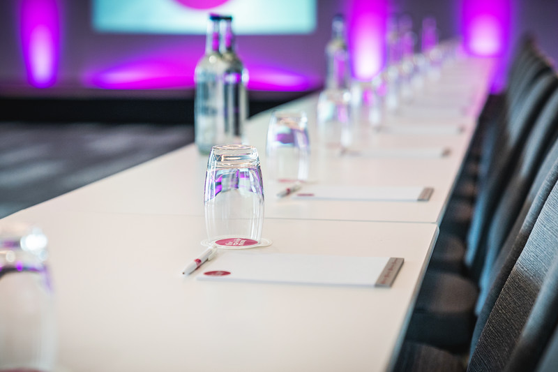 Modern meeting setup at Affinity One, Eastside Rooms with elegant purple lighting. - Banner