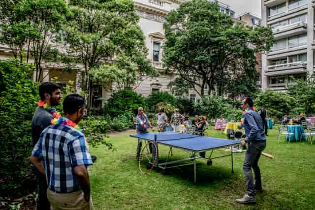 Summer party at Carlton House Terrace with ping pong table and vibrant seating.