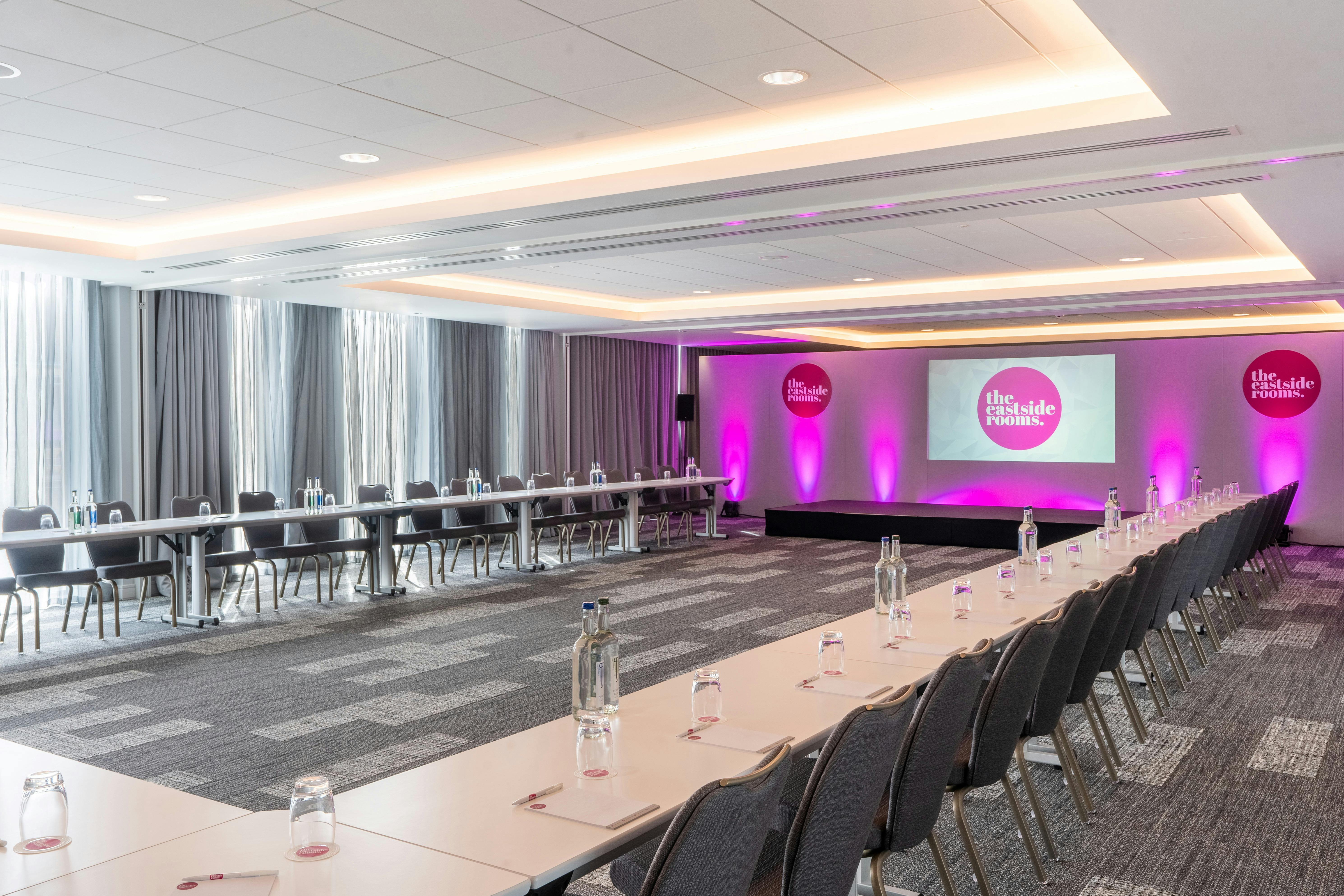 Modern meeting room with long table, ideal for conferences and professional events.