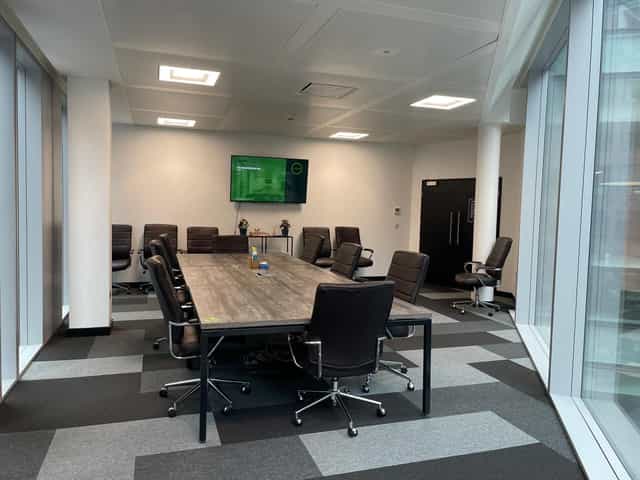 Modern SPS Boardroom with central table, ideal for meetings and presentations.