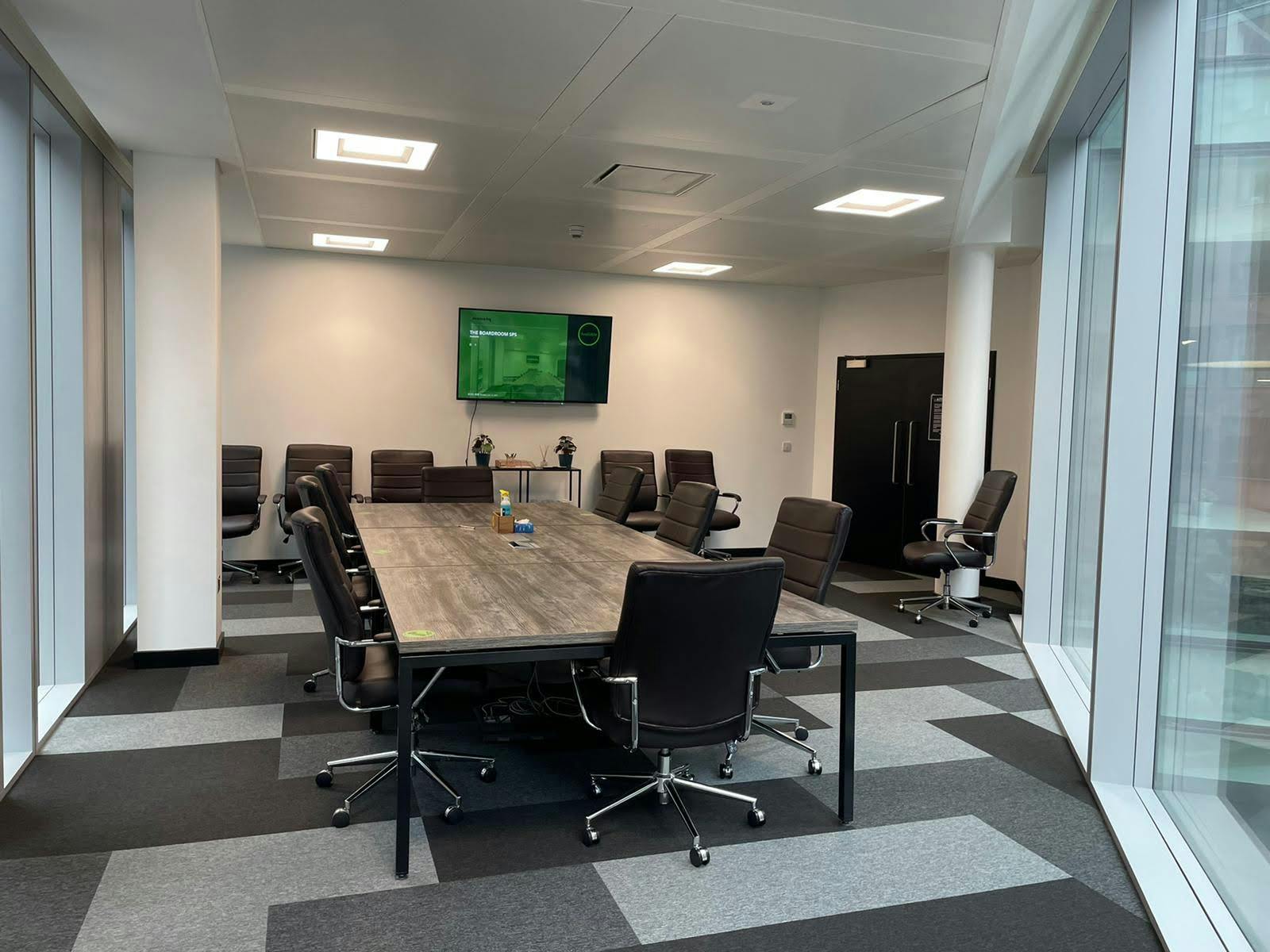 Modern SPS Boardroom with central table, ideal for corporate meetings and presentations.