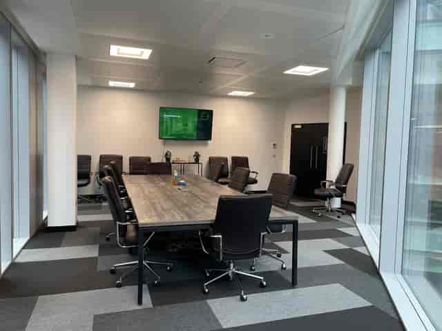 Modern SPS Boardroom with central table, ideal for meetings and presentations.