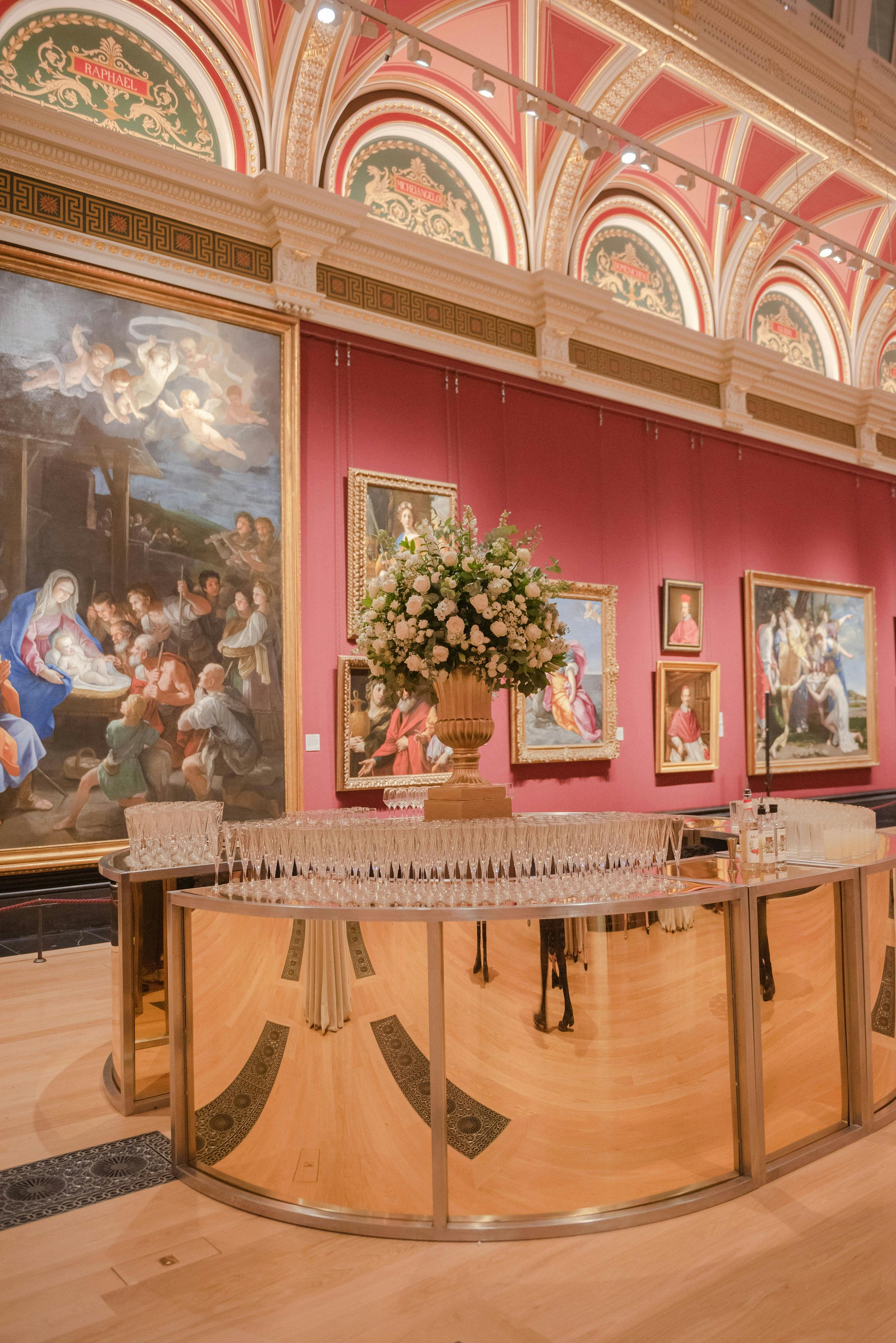 Elegant event space in The National Gallery with bar and floral centerpiece for upscale gatherings.
