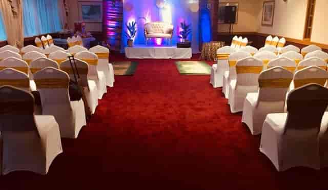 Wansbeck Suite at Britannia Hotel: elegant event space with white chairs and gold sashes.
