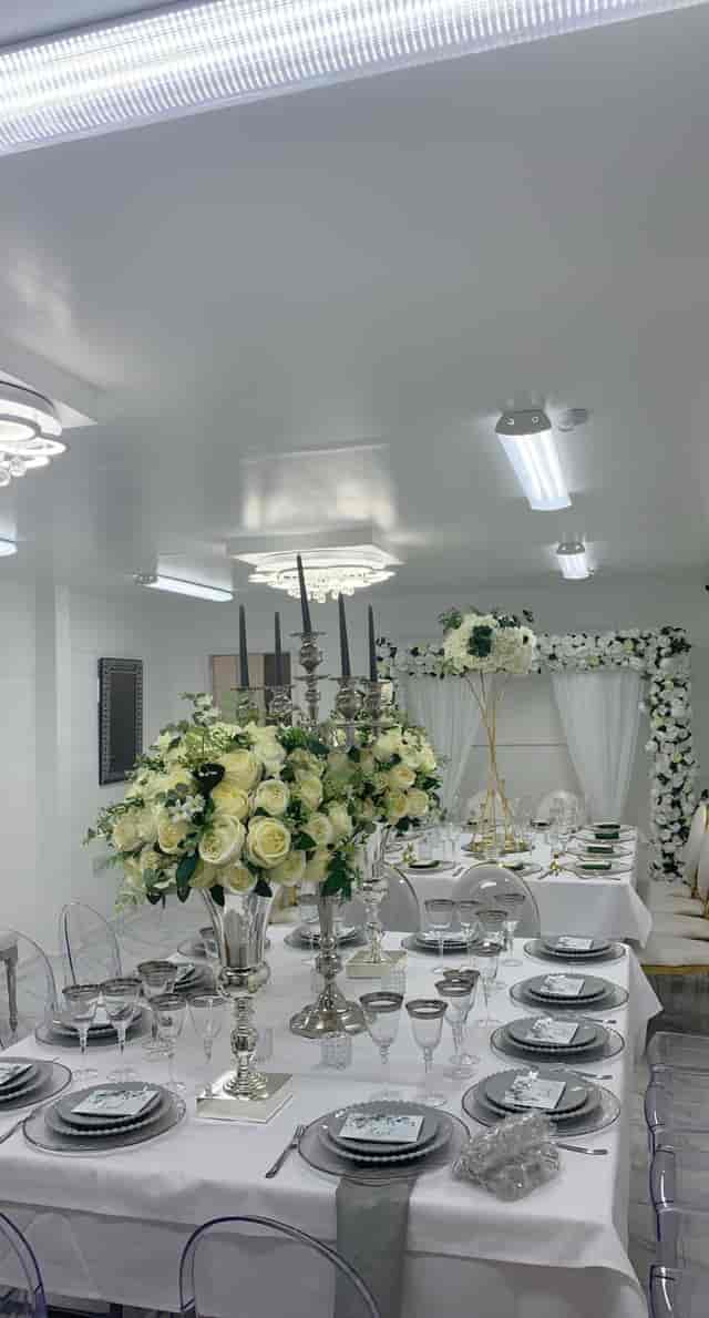 Elegant event space at G LUXE Place with floral centerpieces, perfect for weddings.