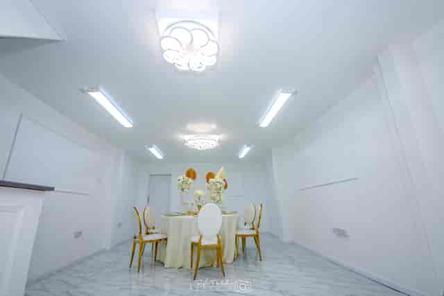 Sleek G LUXE Place event space with floral centerpieces for corporate meetings and celebrations.