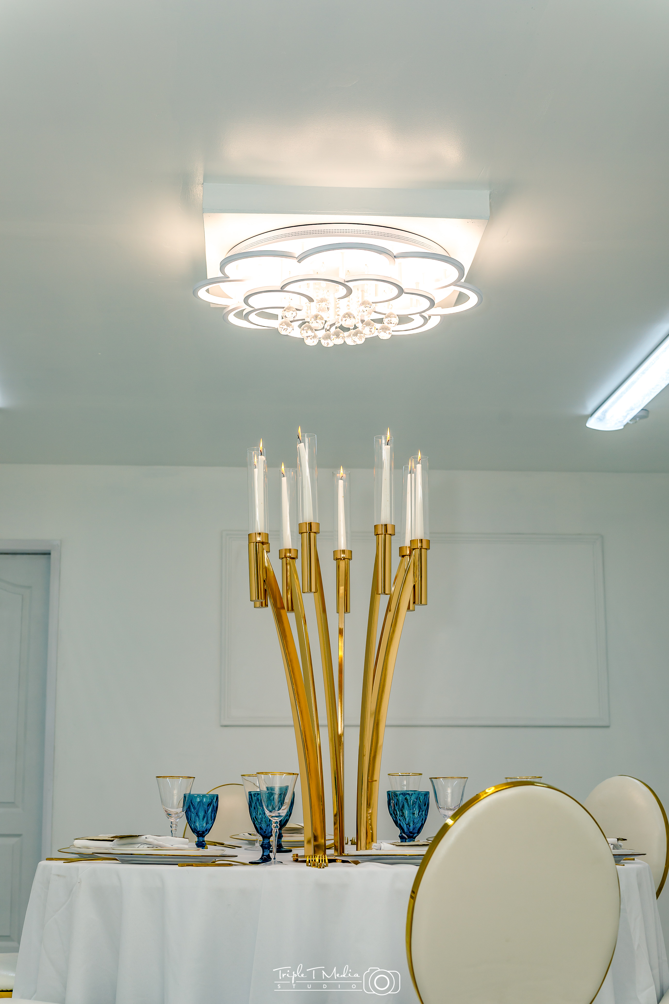 Elegant chandelier with gold accents for upscale events at G LUXE Place.