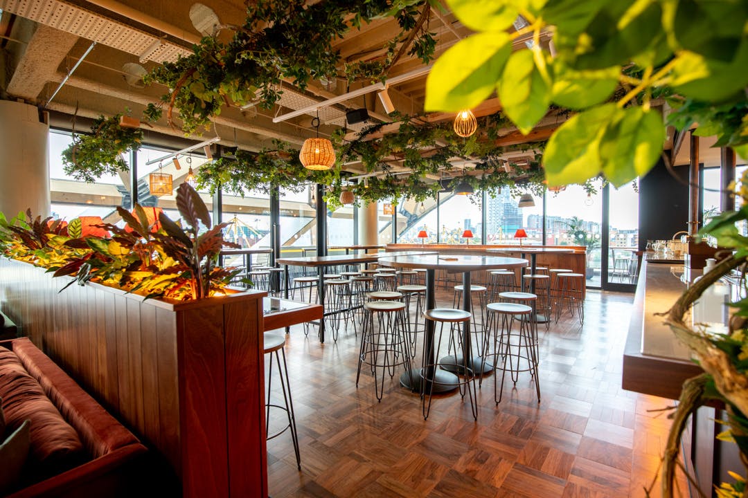Stylish Billingsgate event space with greenery, ideal for gatherings and formal events.