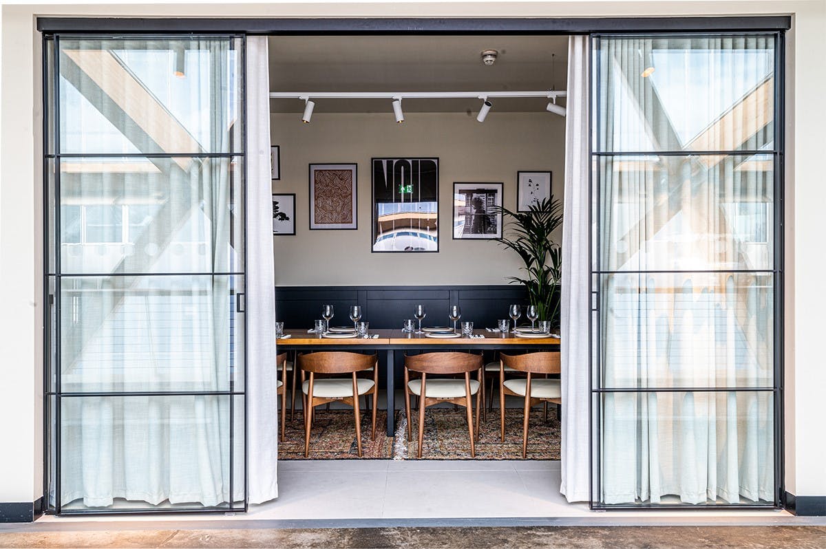 Private dining room with long table, ideal for corporate meetings and workshops.