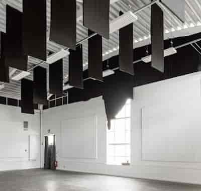 Industrial event venue at Cre8 Studio London featuring acoustic baffles for sound control.