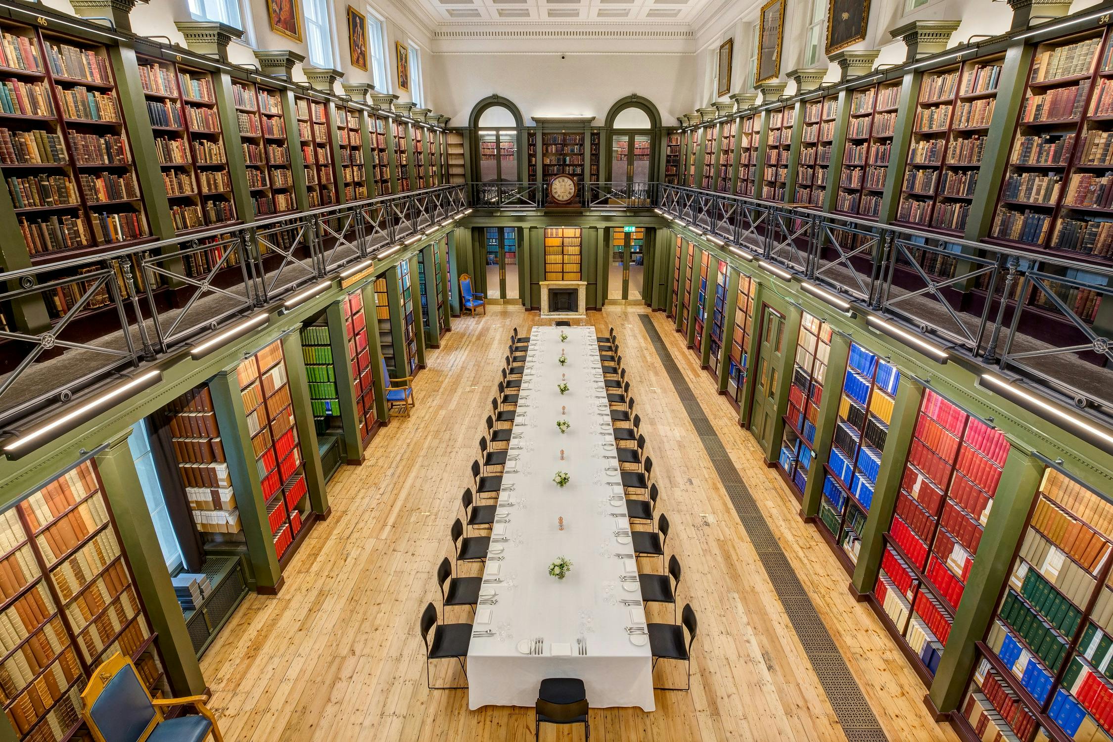 Elegant library with towering bookshelves for corporate meetings and events.
