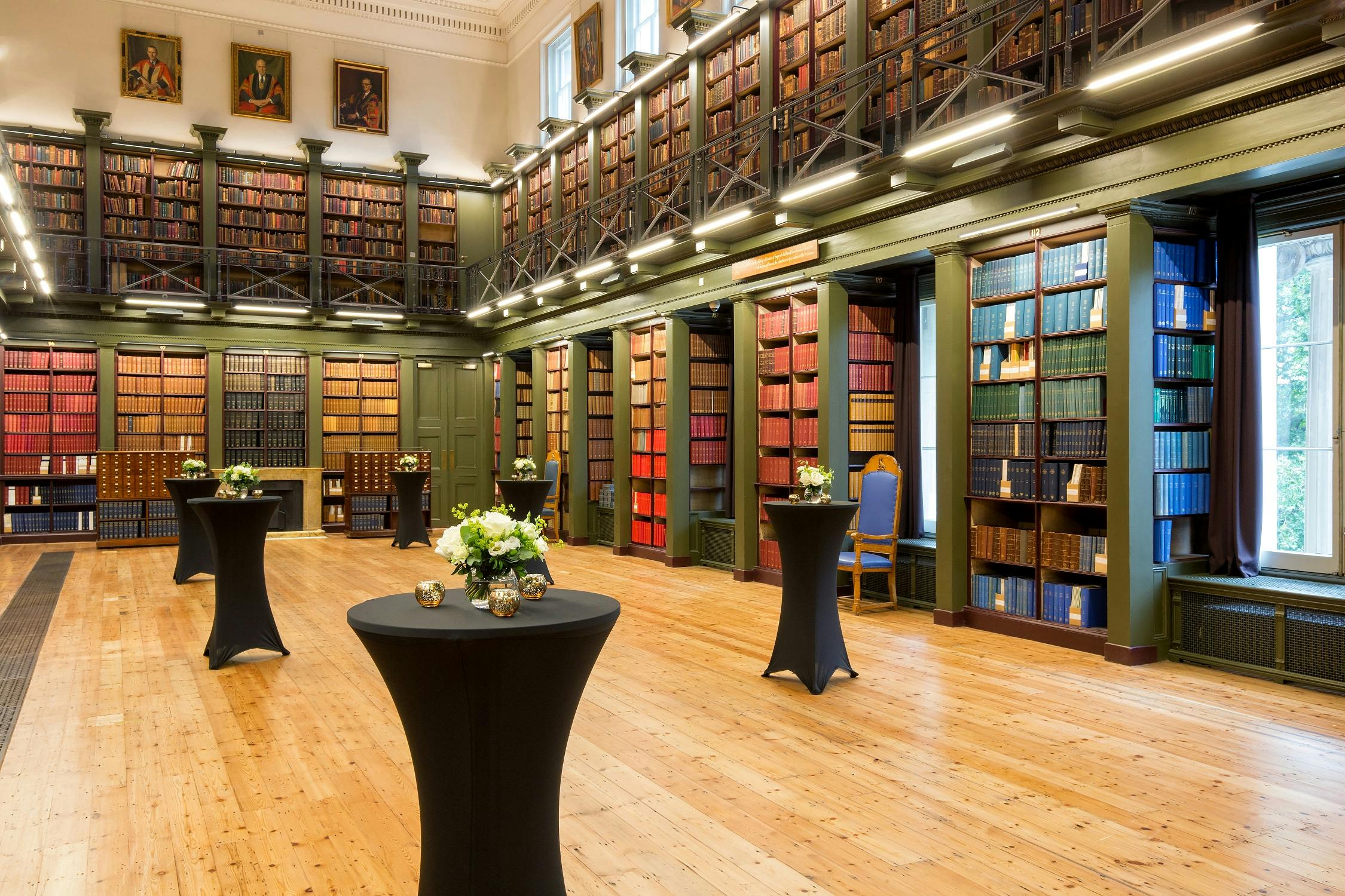 Elegant event space with floral high-tops, perfect for networking and gatherings.