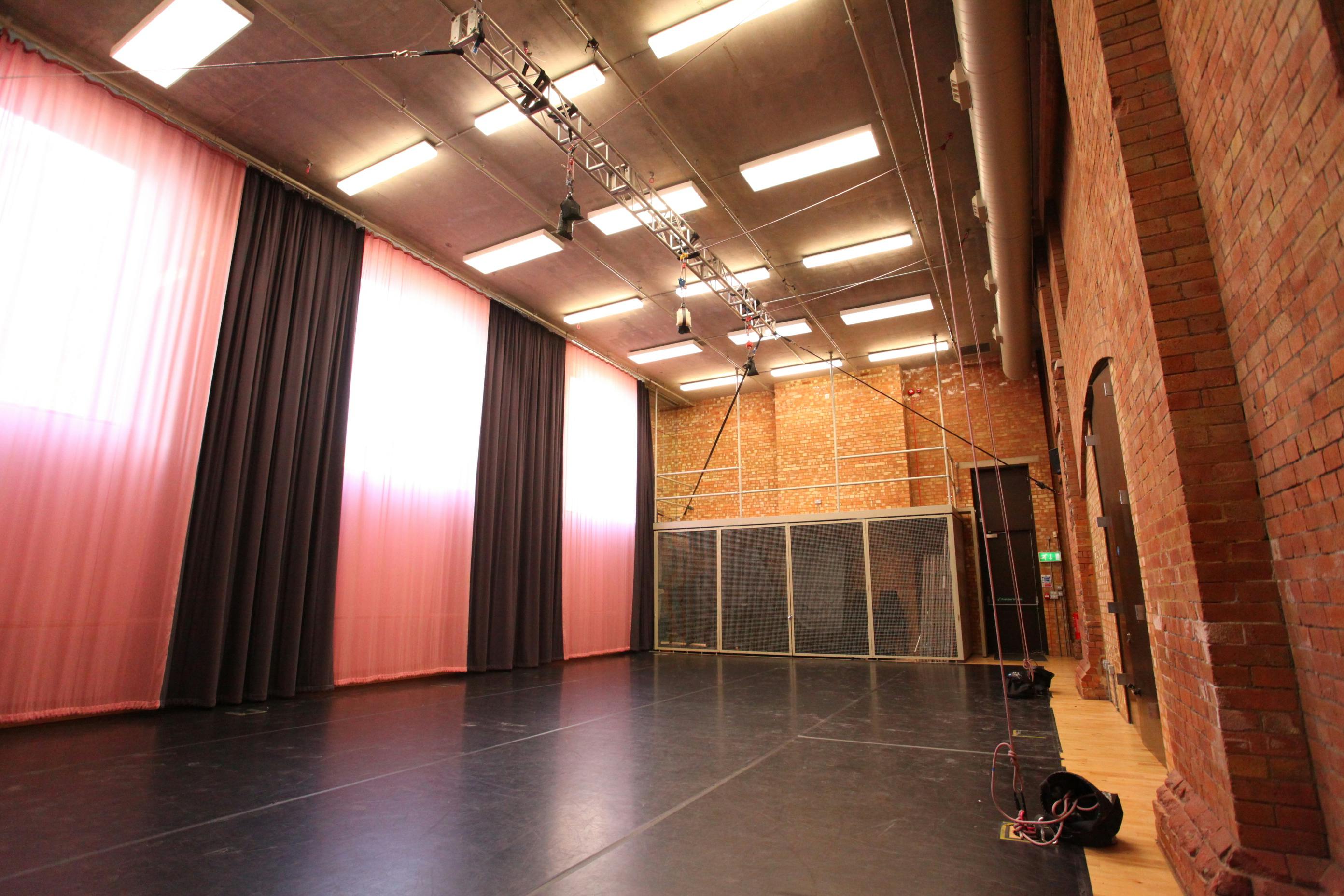 Versatile event space in Shoreditch with polished black floor for performances and gatherings.