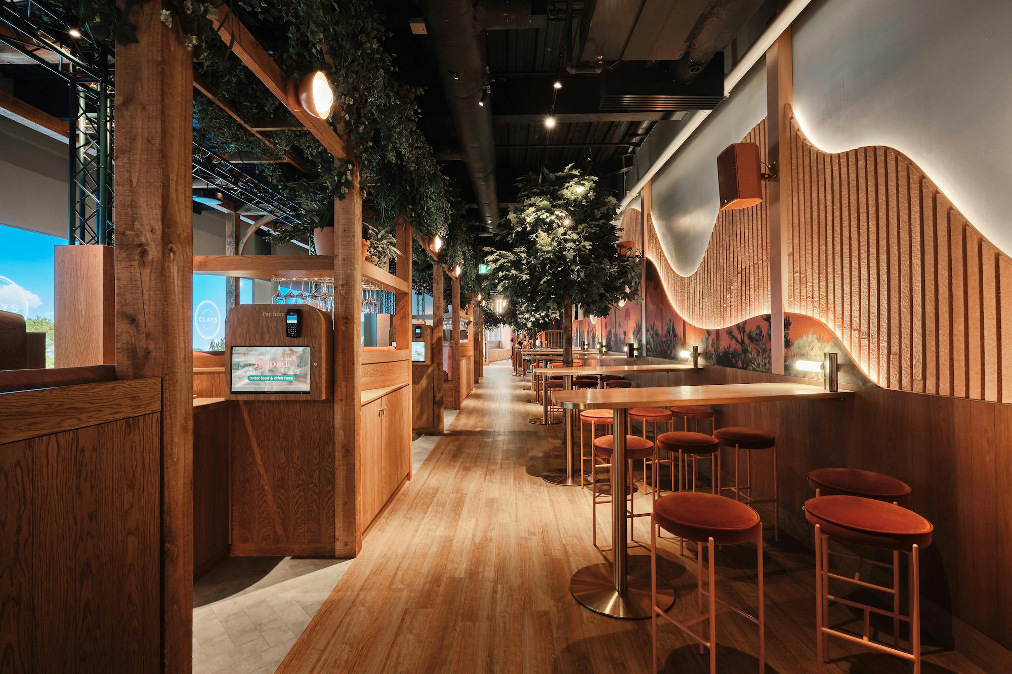 Modern event space at Clays Canary Wharf with warm wood tones, ideal for gatherings and meetings.