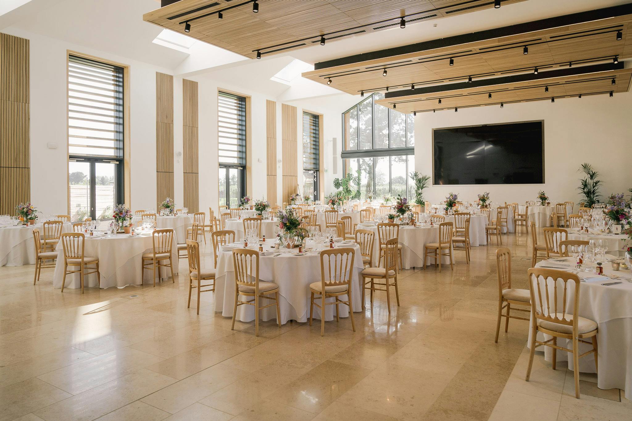 Hilltop Garden Room at RHS Wisley, elegant wedding venue with natural light and floral decor.