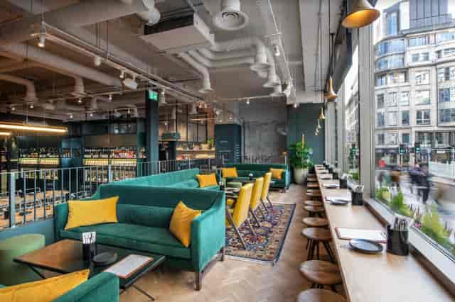 Modern lounge with vibrant seating, ideal for meetings and events in urban setting.