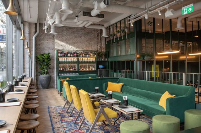 Modern lounge with vibrant green seating, ideal for casual meetings and events.