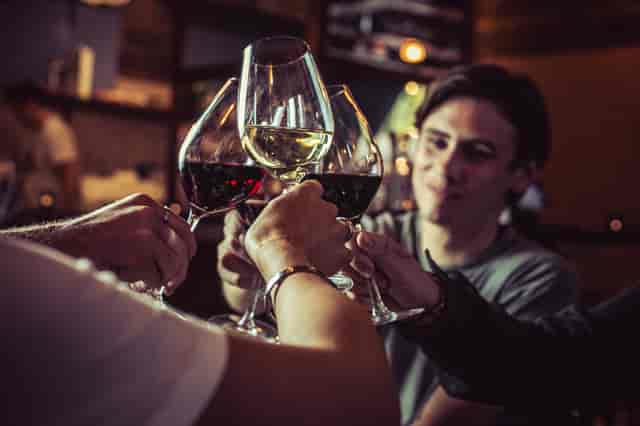 Celebratory toast at VAGABOND MONUMENT, showcasing networking and curated wines.