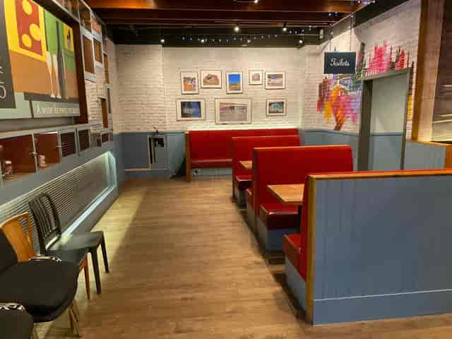Cozy LDN Craft bar with red booths, perfect for informal meetings and gatherings.