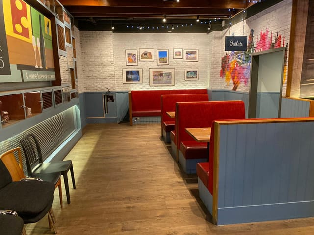 Cozy LDN Craft bar with red booths, perfect for informal meetings and gatherings.