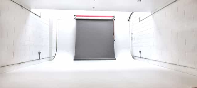 Minimalist photography studio with gray backdrop for events and video shoots.
