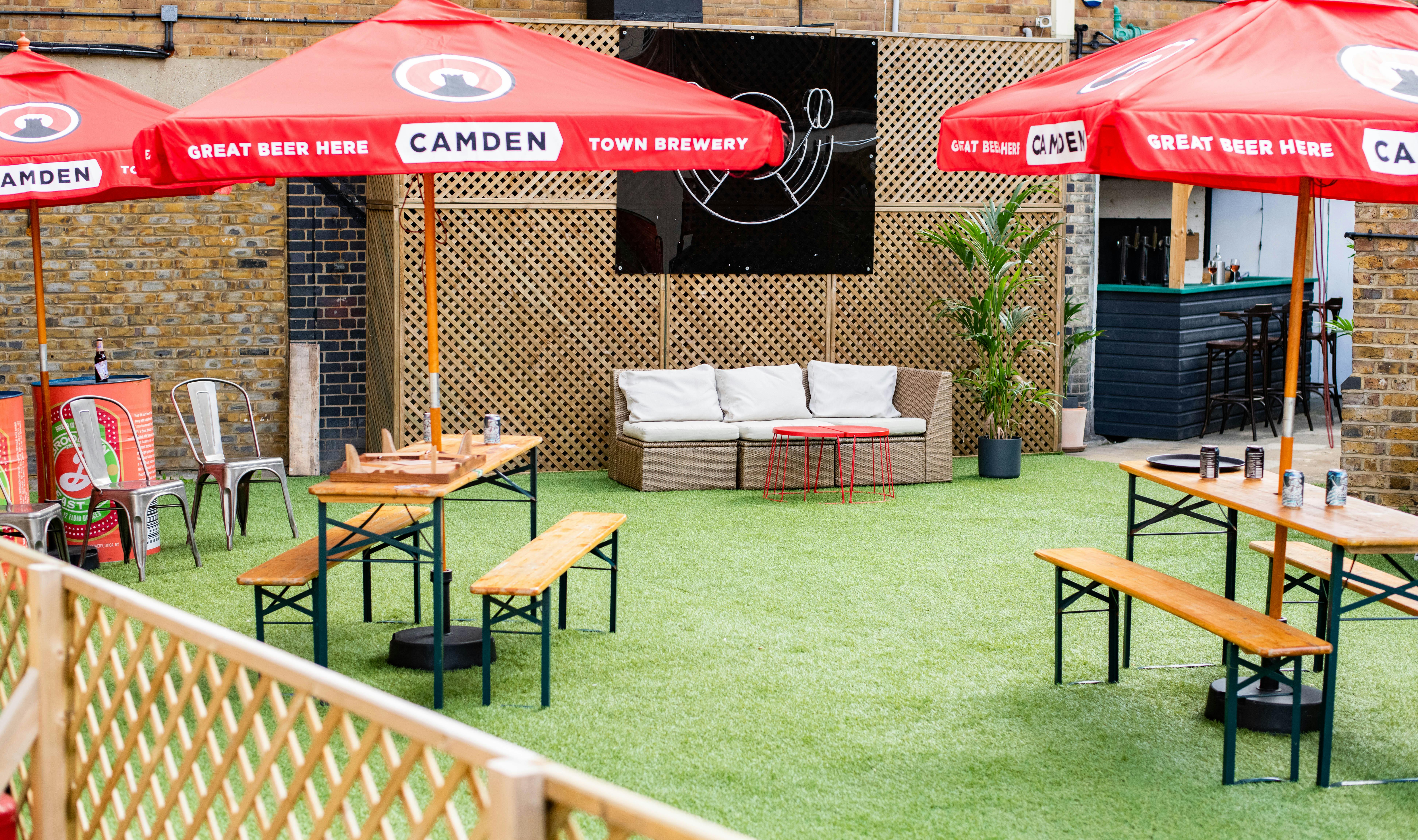 Vibrant outdoor event space with branded umbrellas for casual gatherings in Hackney.