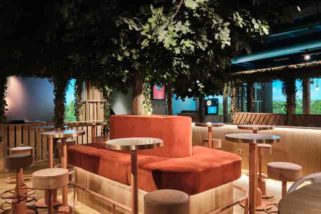Cozy event space with elevated seating and greenery at Booth for 20 in Clays - Moorgate.