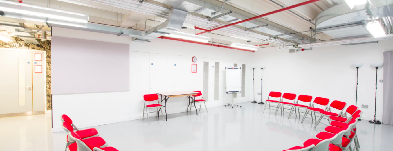 Versatile meeting space with red chairs for workshops at Old Diorama Arts Centre. - Banner