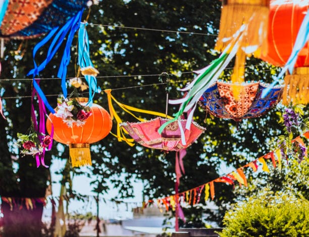 Vibrant outdoor event space with colorful lanterns for weddings and festivals.