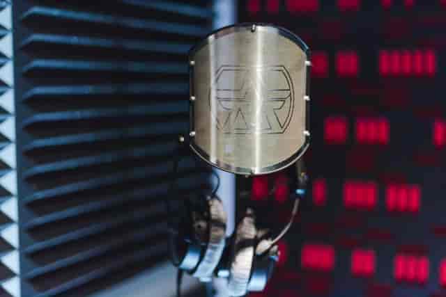 Professional microphone in soundproof studio for podcasts and live events.