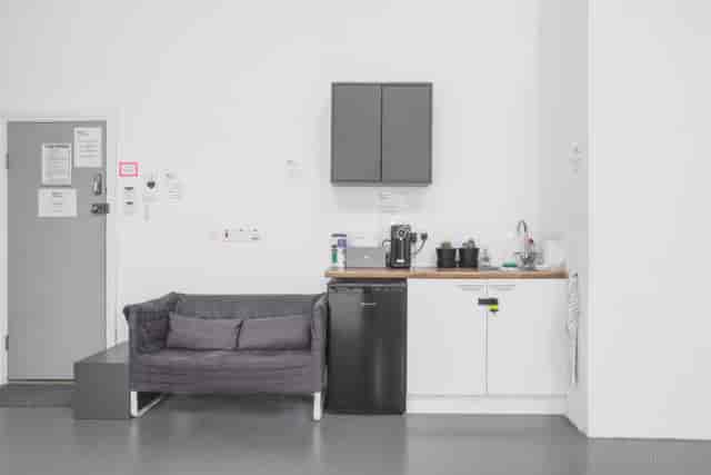 Minimalist break area at Ctrl Creative Camden with cozy couch for meetings and events.