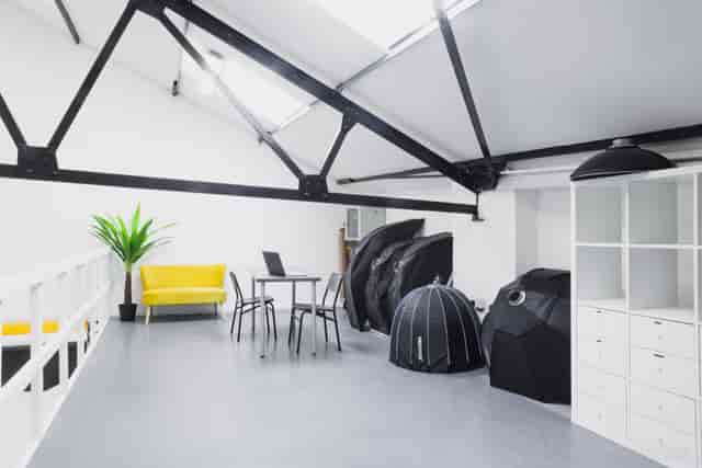 Versatile event space with yellow couch, perfect for meetings and workshops.