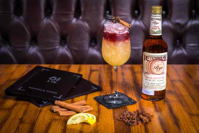 Artisanal cocktail with cinnamon stick, perfect for upscale events and receptions.