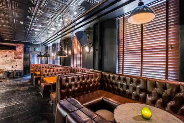 Stylish venue with leather booths, ideal for networking events and intimate gatherings.