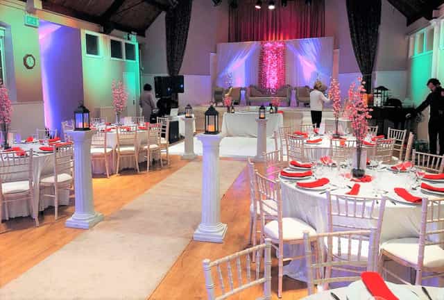 Elegant event space with round tables, ideal for weddings and formal gatherings.