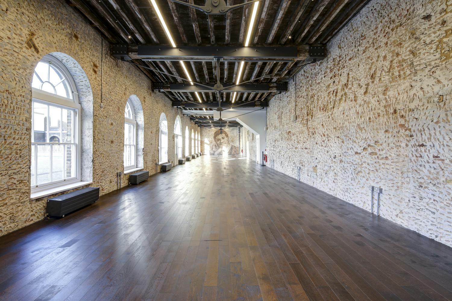 Spacious Knight Gallery venue with exposed brick, perfect for corporate events and gatherings.