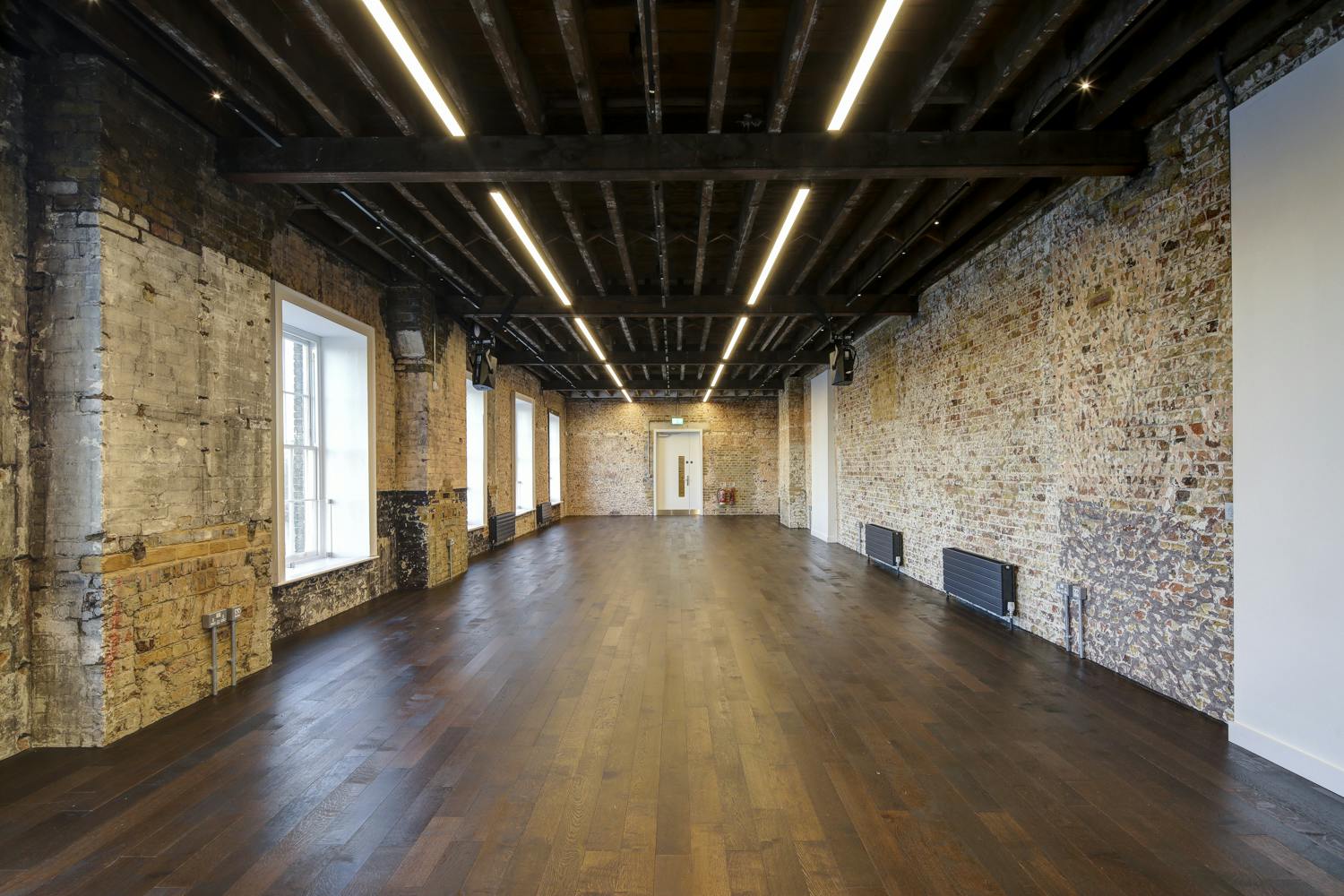 Beanfeast event space in Woolwich Works with exposed brick and natural light for gatherings.