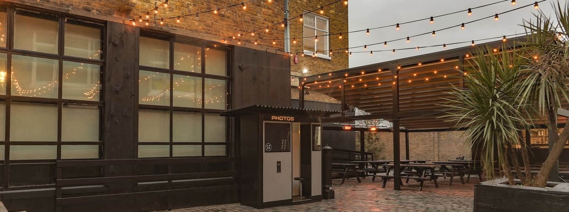 Charming outdoor courtyard at 93 Feet East with string lights for events and gatherings.