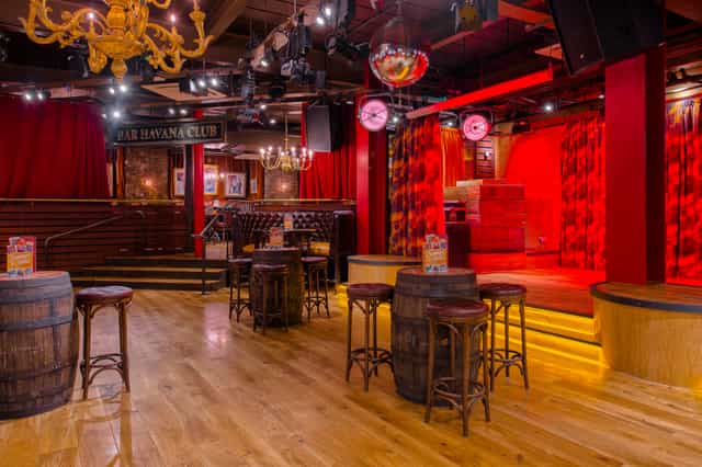 Vibrant Santiago Bar in Manchester with rustic barrel tables for events and gatherings.