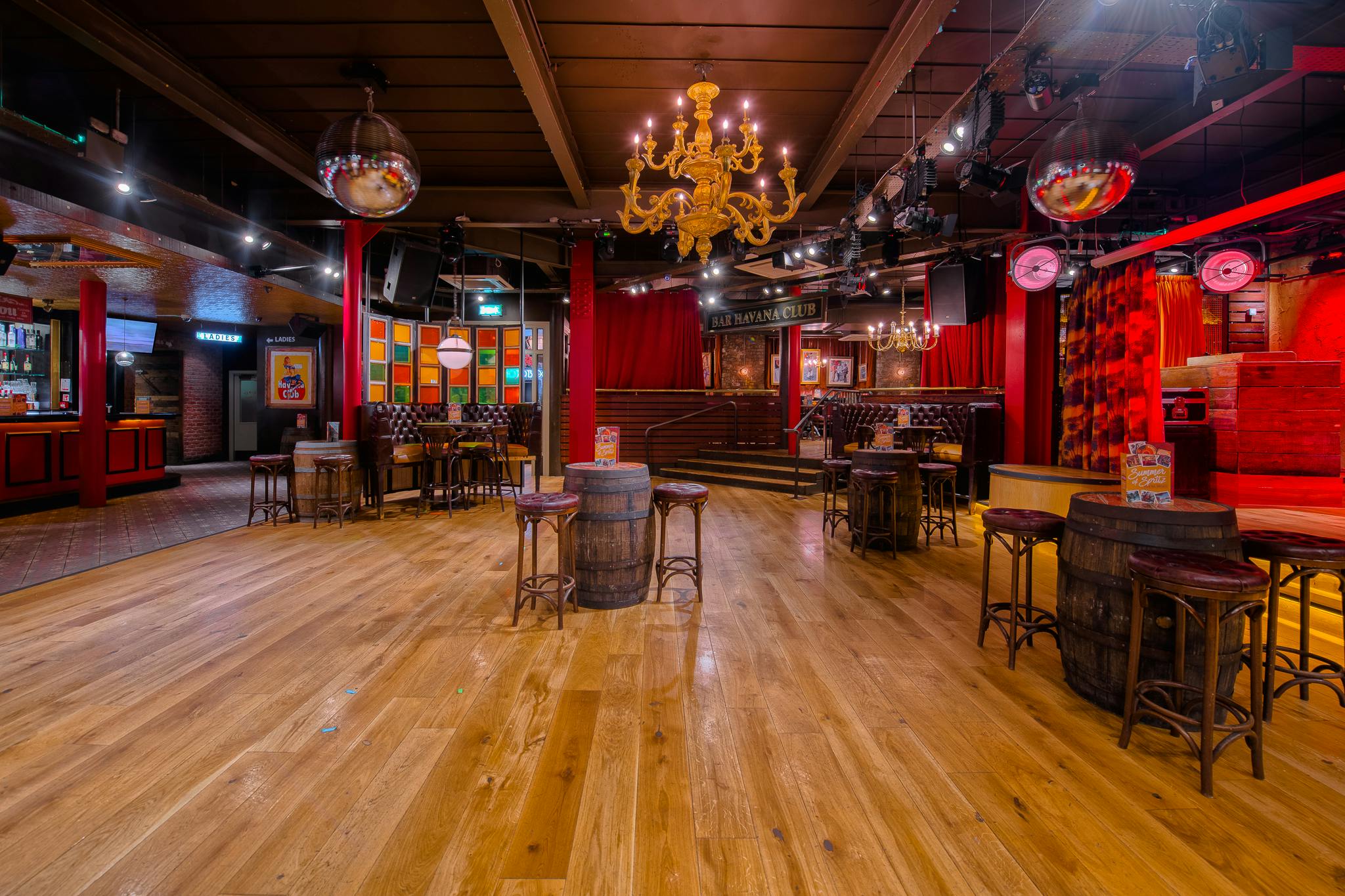 Versatile event space in Revolución de Cuba Manchester with wooden flooring, ideal for parties.