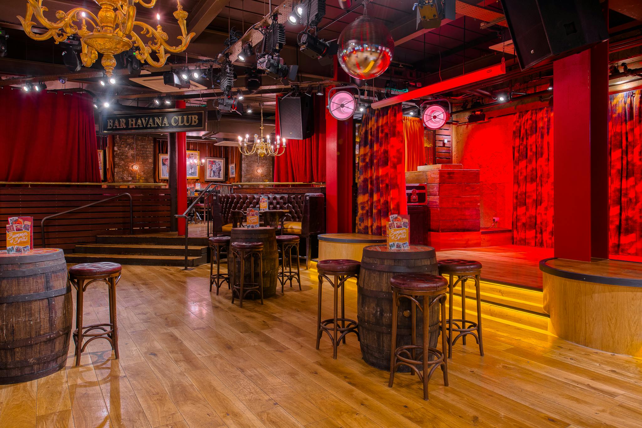 Vibrant event space with rustic barrel tables at Revolución de Cuba Manchester.