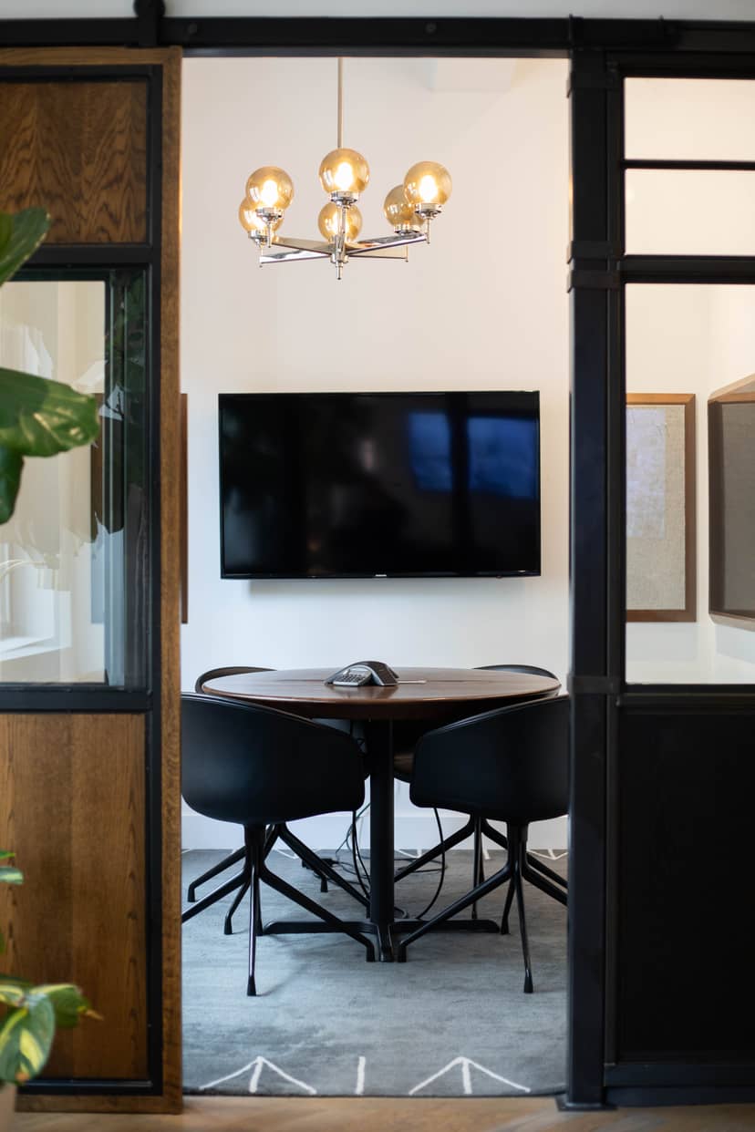 Modern meeting room with round table, ideal for collaboration and presentations.